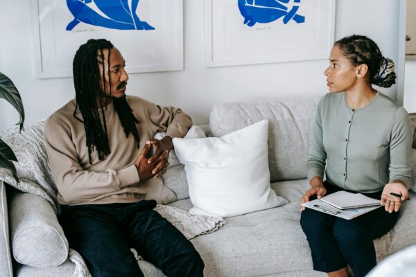 man chatting with female counselor