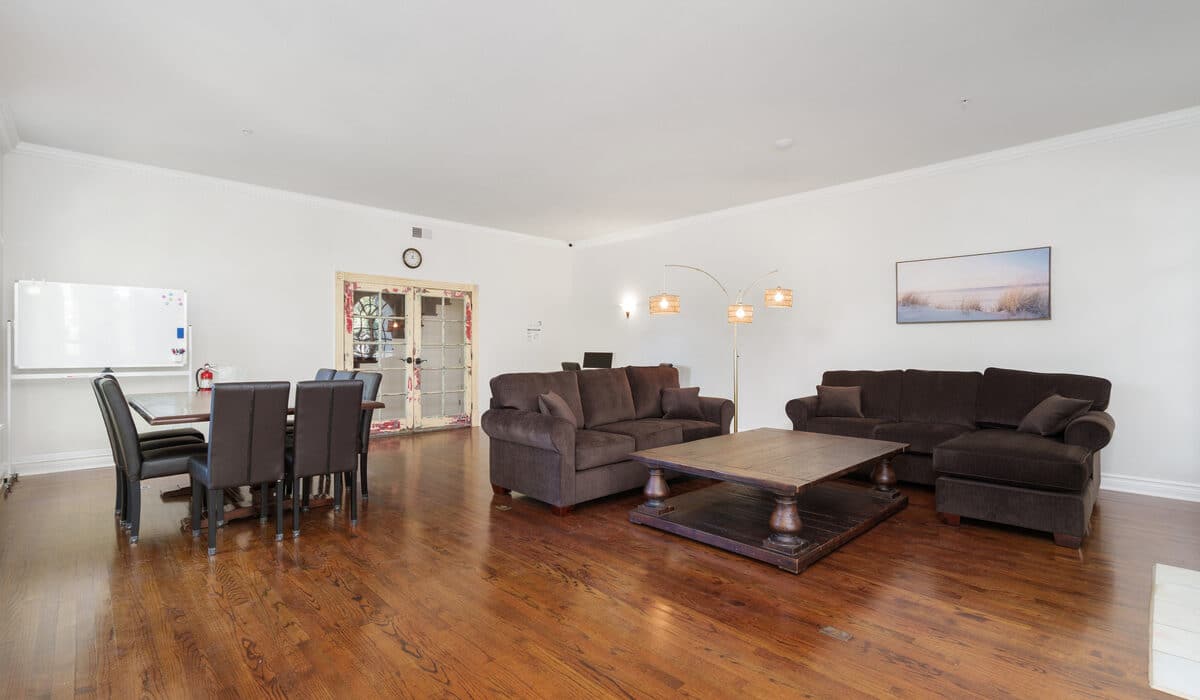 Living room area with a couch, table, and tv