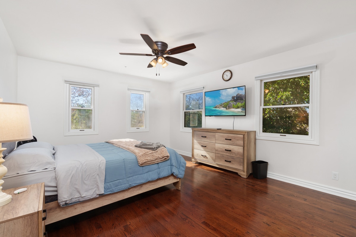 A bedroom with a dresser and tv