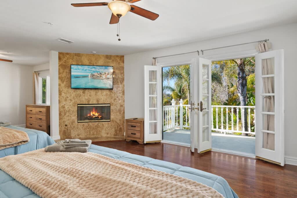 a bedroom with an entrance to a balcony