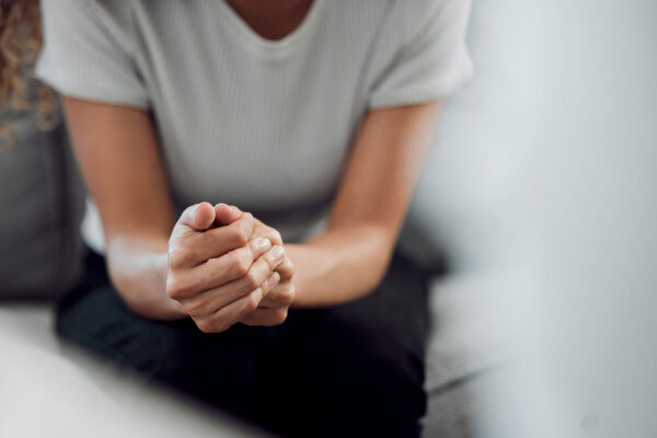 woman sitting alone and feeling anxious during addiction treatment