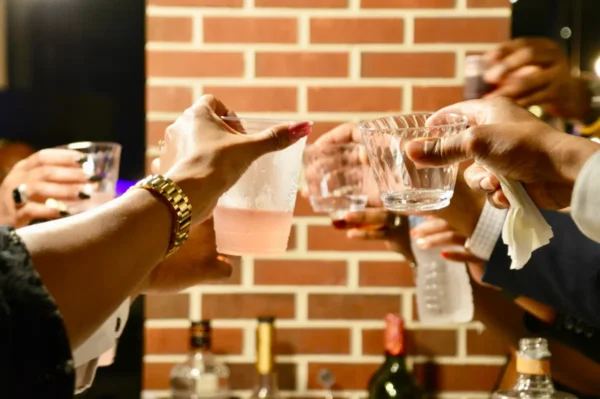A group of people toasting alcoholic drinks