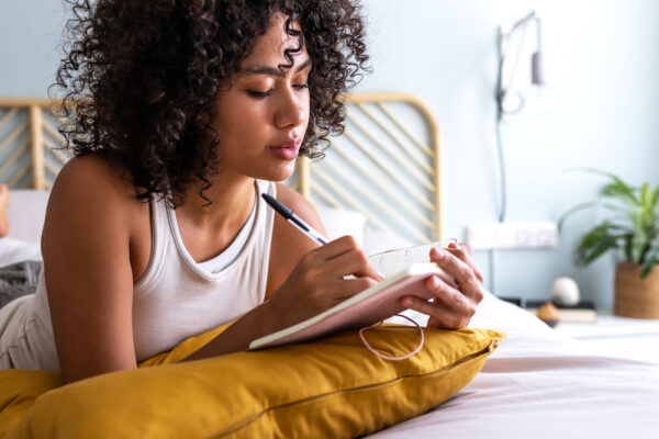 Individual practicing cognitive behavioral therapy exercises to support addiction recovery