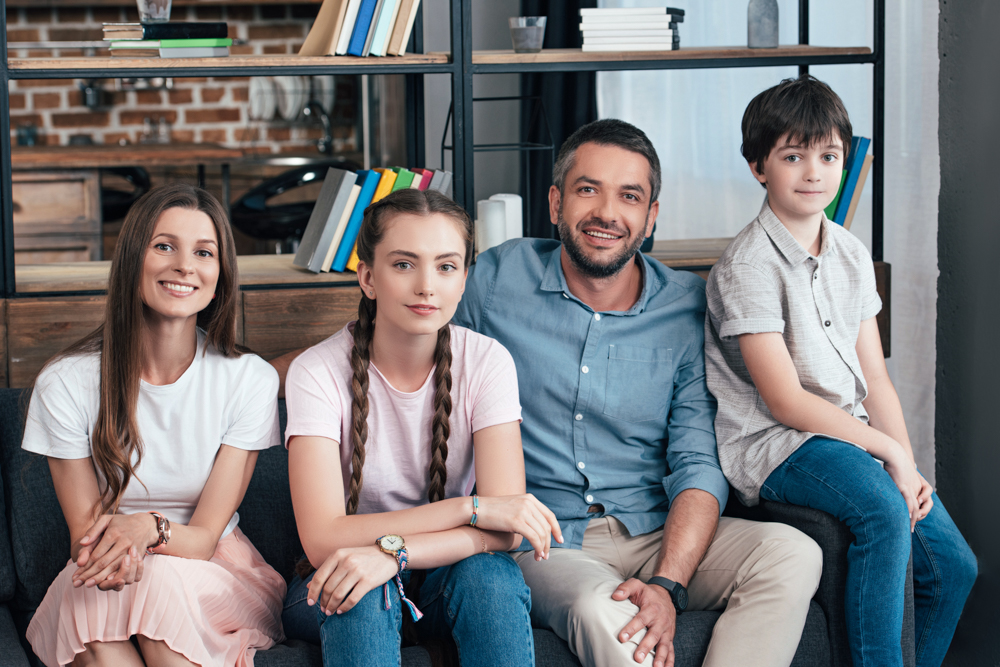 Family relaxing together on a living room couch